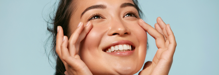 woman smiling touching her face