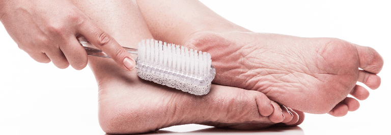 woman scrubbing foot