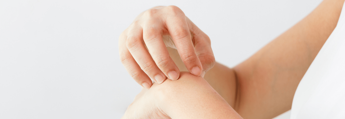 scratching top of hand