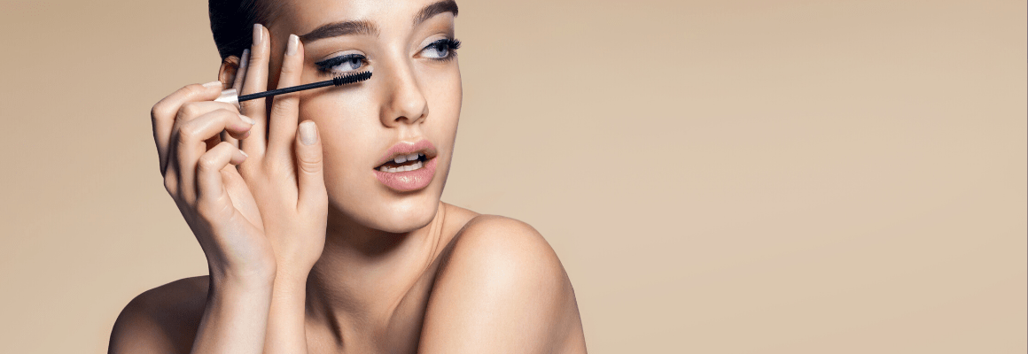 woman putting on mascara