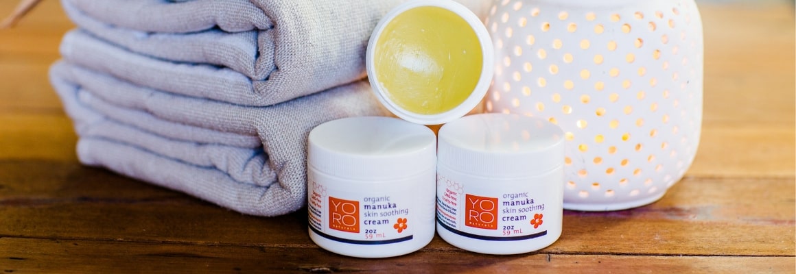 jars of organic manuka skin soothing cream against towels