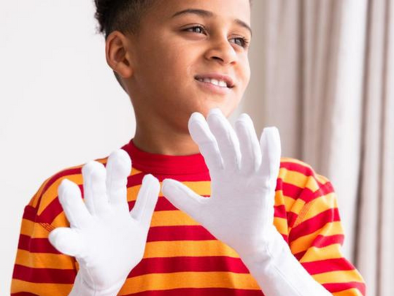 100% Cotton Clothing boy holding up hands with Cotton Gloves
