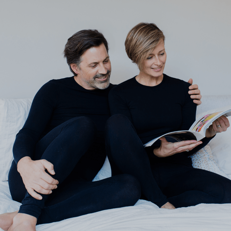 Remedywear - wife and husband in Black Remedywear garments on couch reading