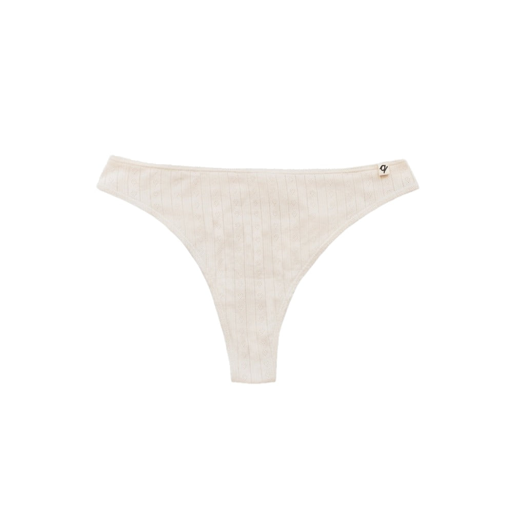 Natural organic cotton pointelle thong laid flat, breathable no-show underwear for sensitive skin