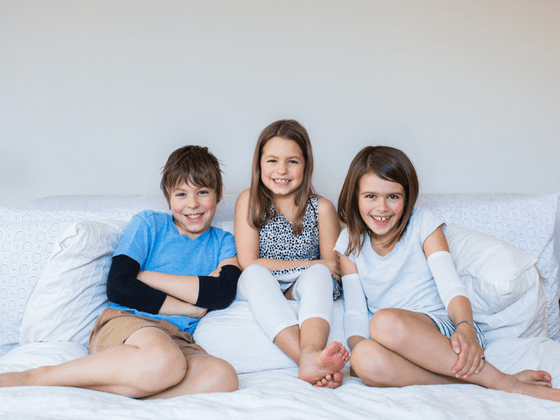 Remedywear Clothing - Kids on Bed smiling