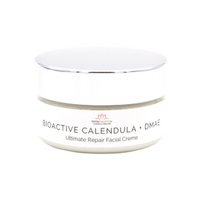 Front of calendula facial cream jar. Metal lid with white label.