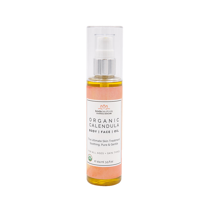 Bottle of organic calendula oil for eczema on a white background.