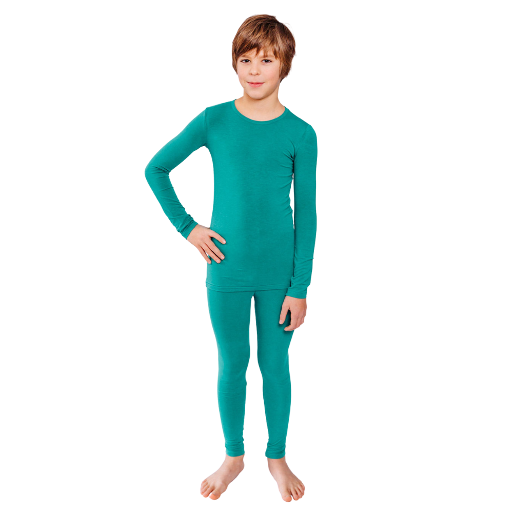 Boy with hand on hip wearing teal Remeywear long sleeve shirt and long pants.