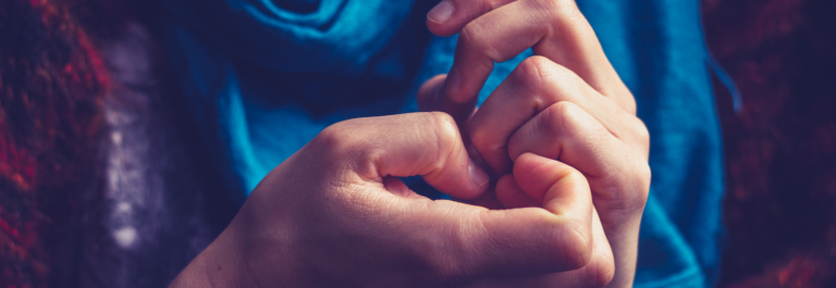woman picking at her skin on hands