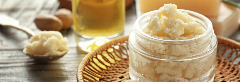 jar of shea butter sitting on a wooden table
