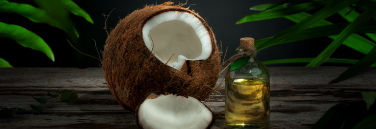 cracked open coconut next to jar of coconut oil for eyelid eczema 