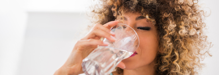 woman drinking glass of water 