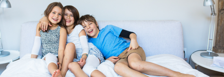 3 kids wearing eczema bandages on arms and legs 