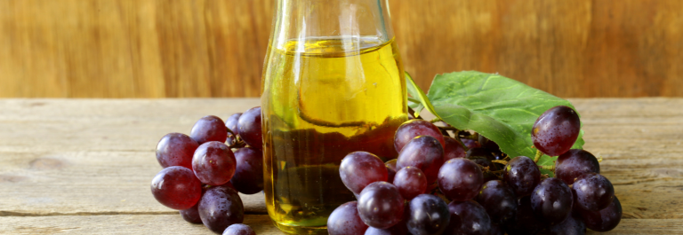 red grapes and jar of grapeseed oil