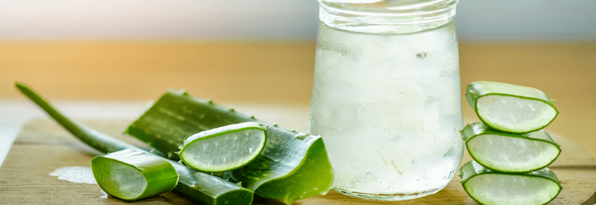 cut up aloe vera next to glass jar
