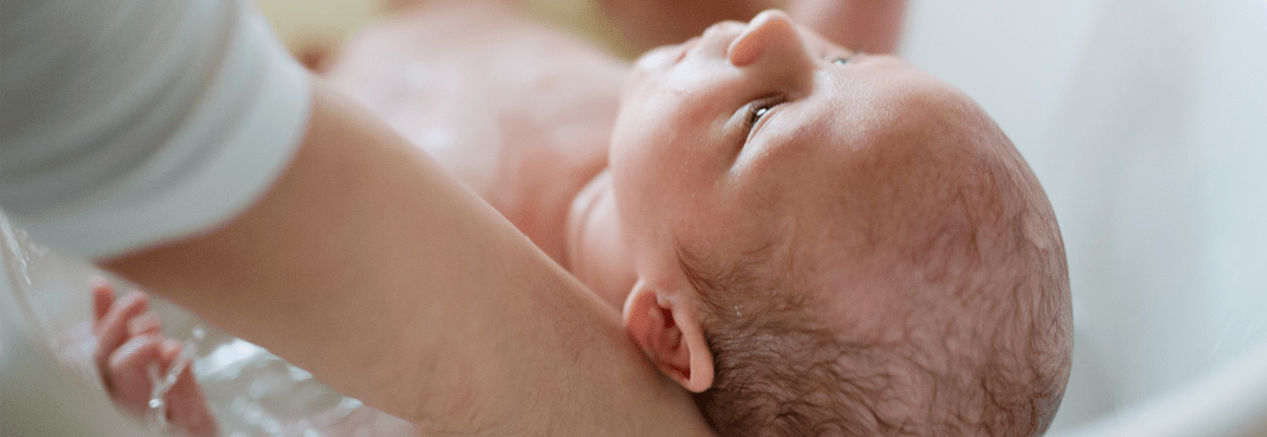 person holding little baby's head