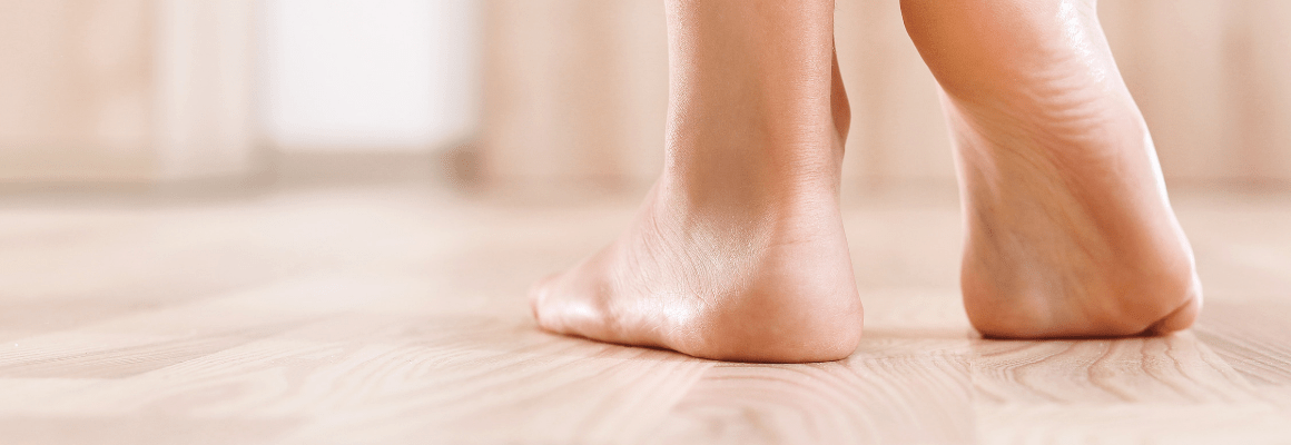 two bare feet on a wood floor