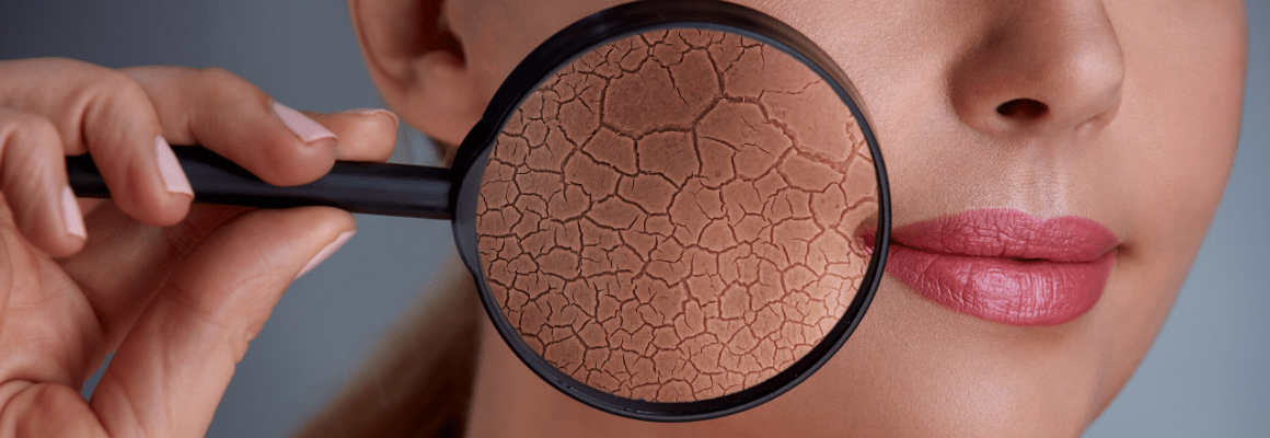 woman holding magnifying glass up to cheek to show skin