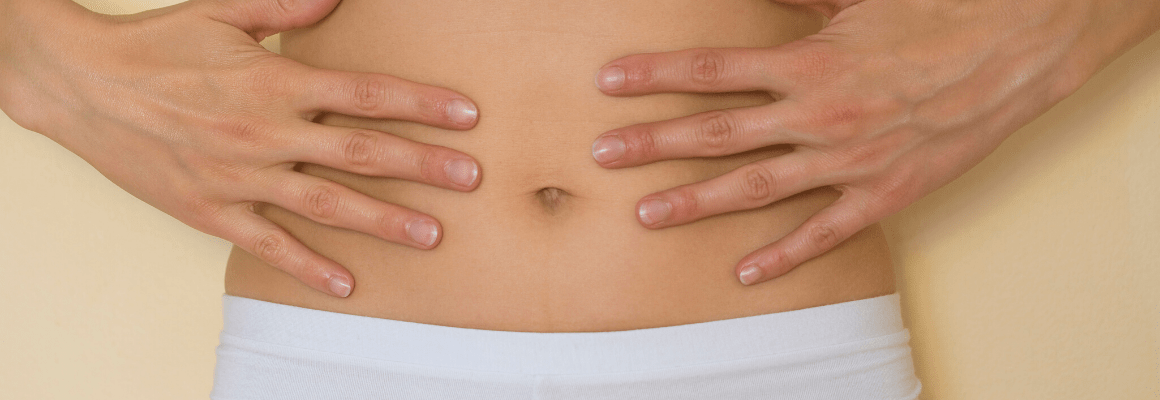 person holding hands around bellybutton