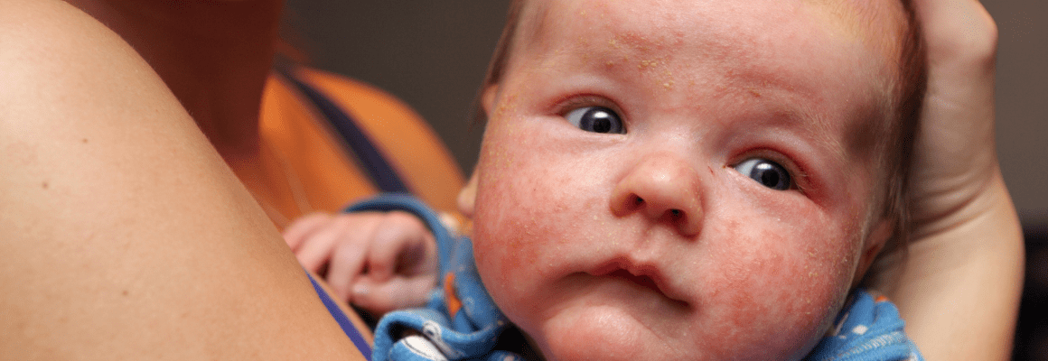 little baby boy being held in someone's arms