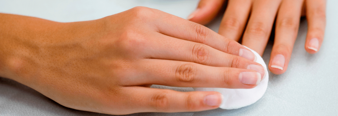 woman wiping nails with white cotton swap