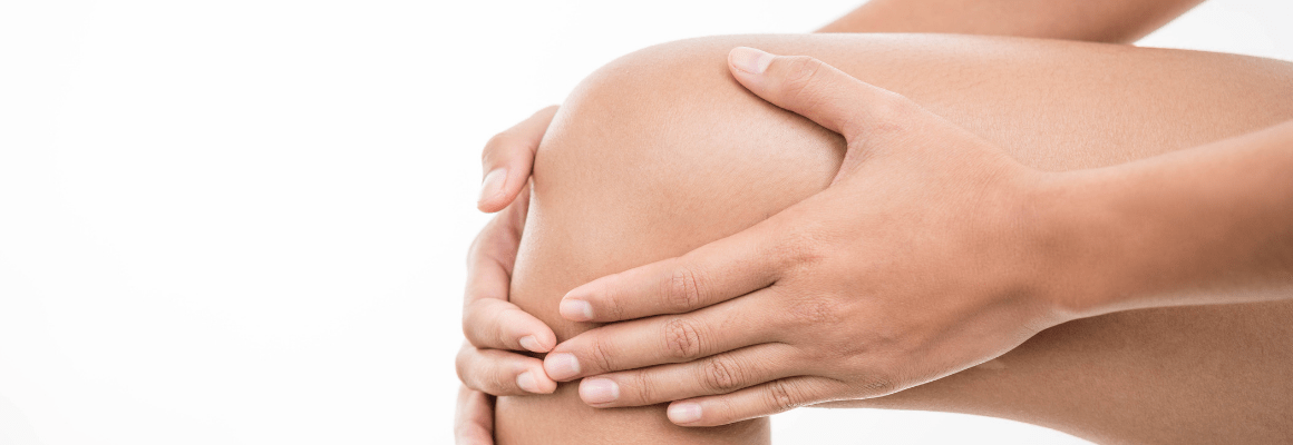 Woman with hands on knee eczema.