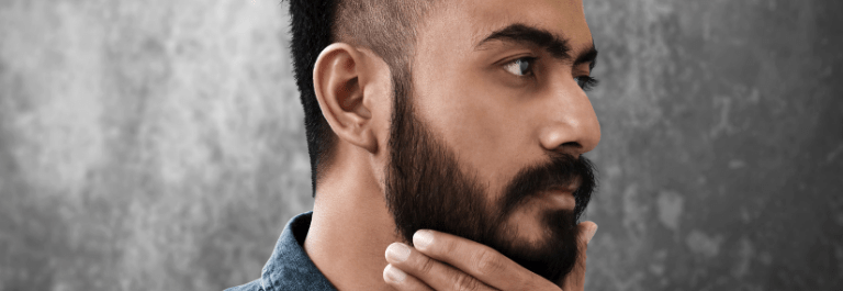man touching his beard