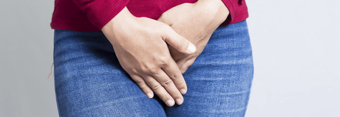 person holding hands over groin area