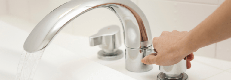 woman turning on tap