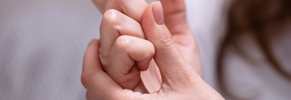 person scratching eczema on knuckles