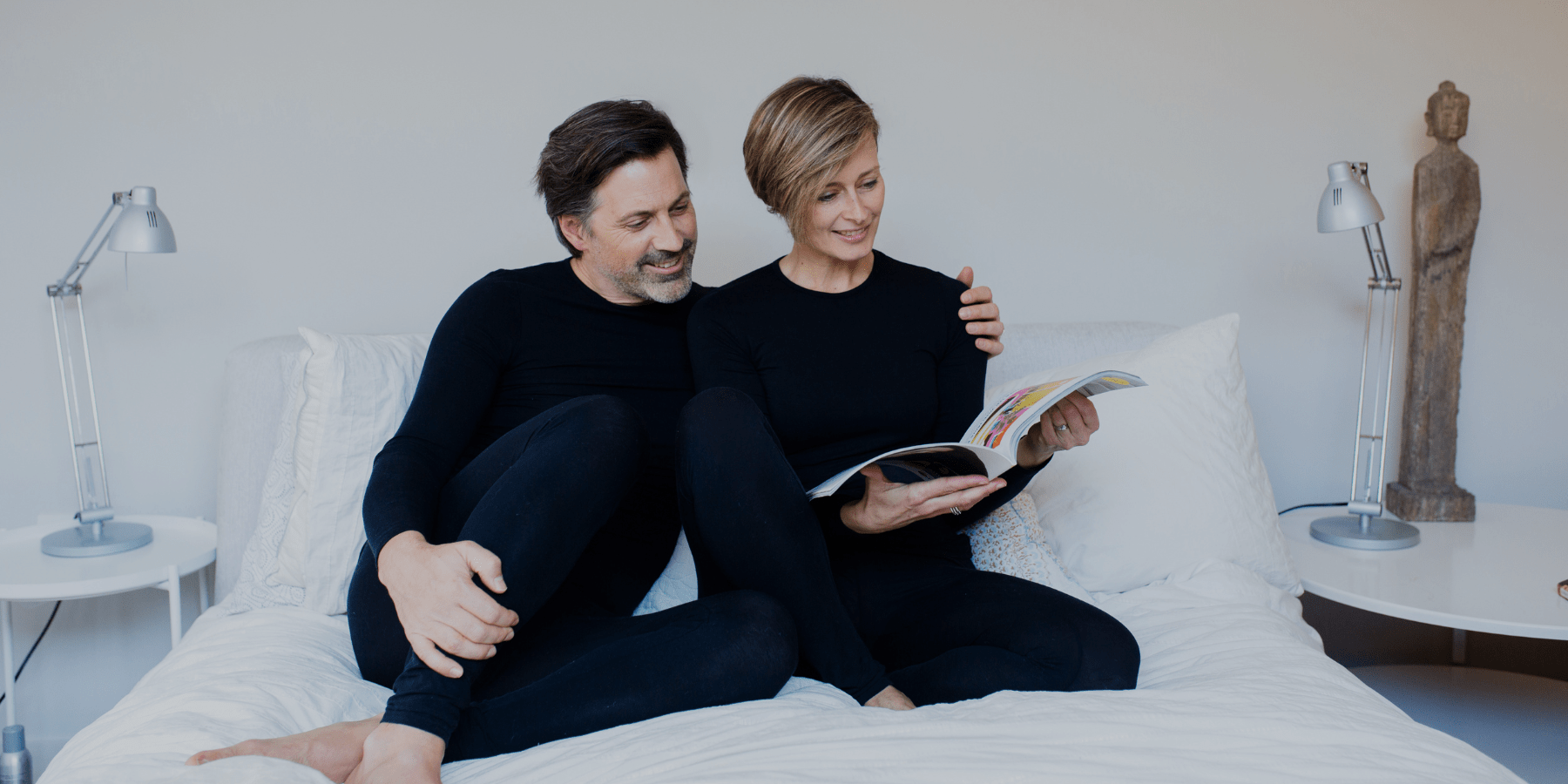 Remedywear - wife and husband in Black Remedywear garments on couch reading