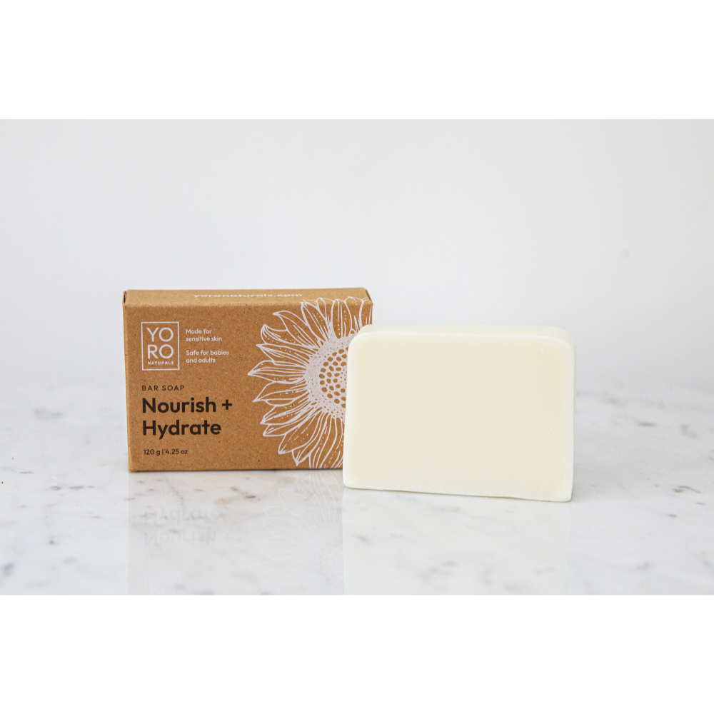 Nourish + Hydrate oil soap bar sitting next to it's box in kraft cardboard