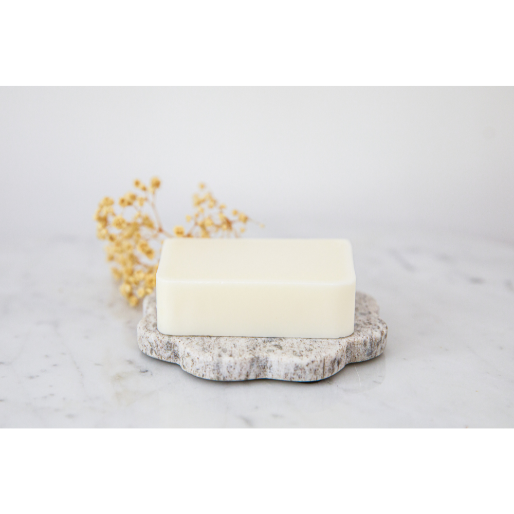 1 Nourish + Hydrate oil soap bar on top of a soap tray