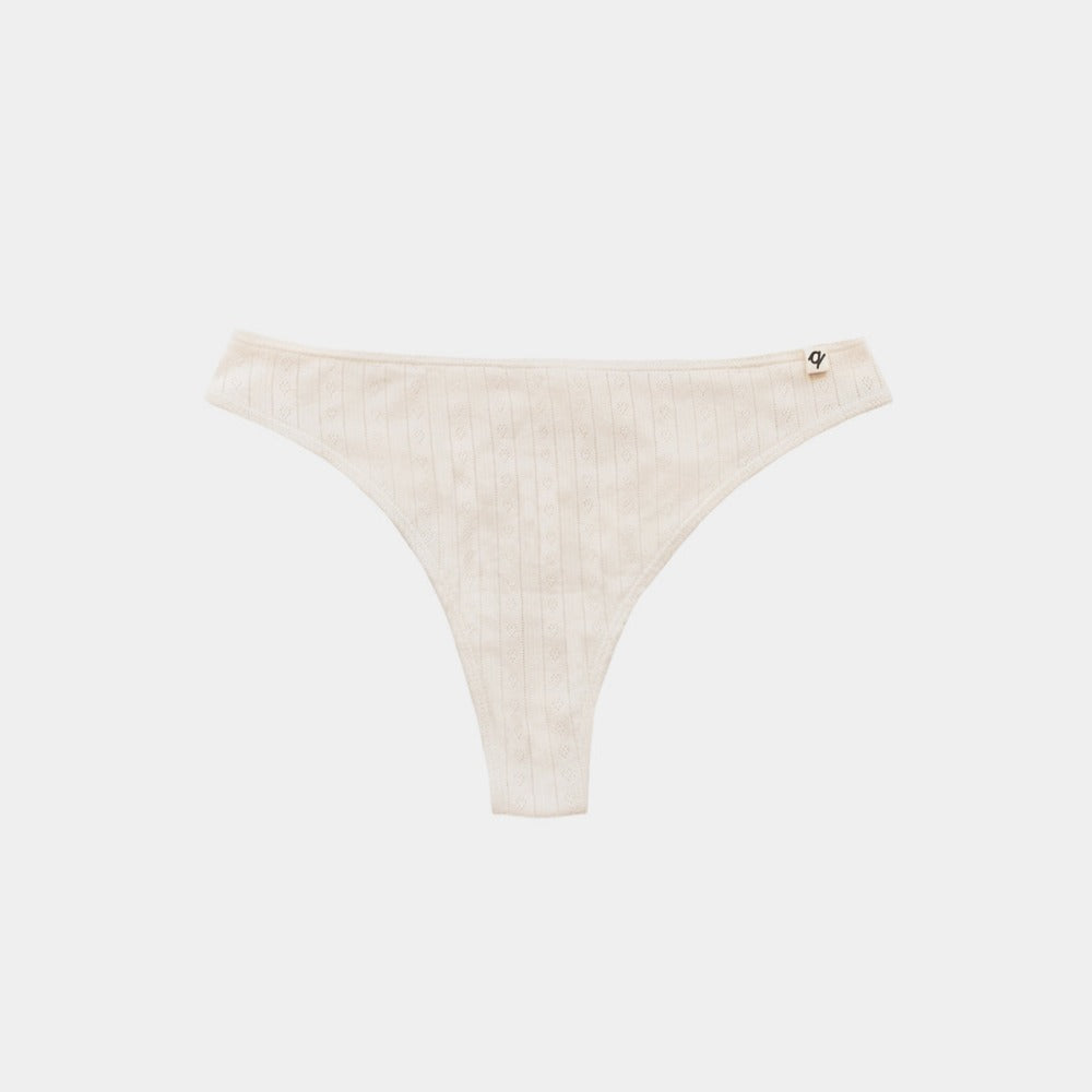 Natural organic cotton pointelle thong laid flat, breathable no-show underwear for sensitive skin