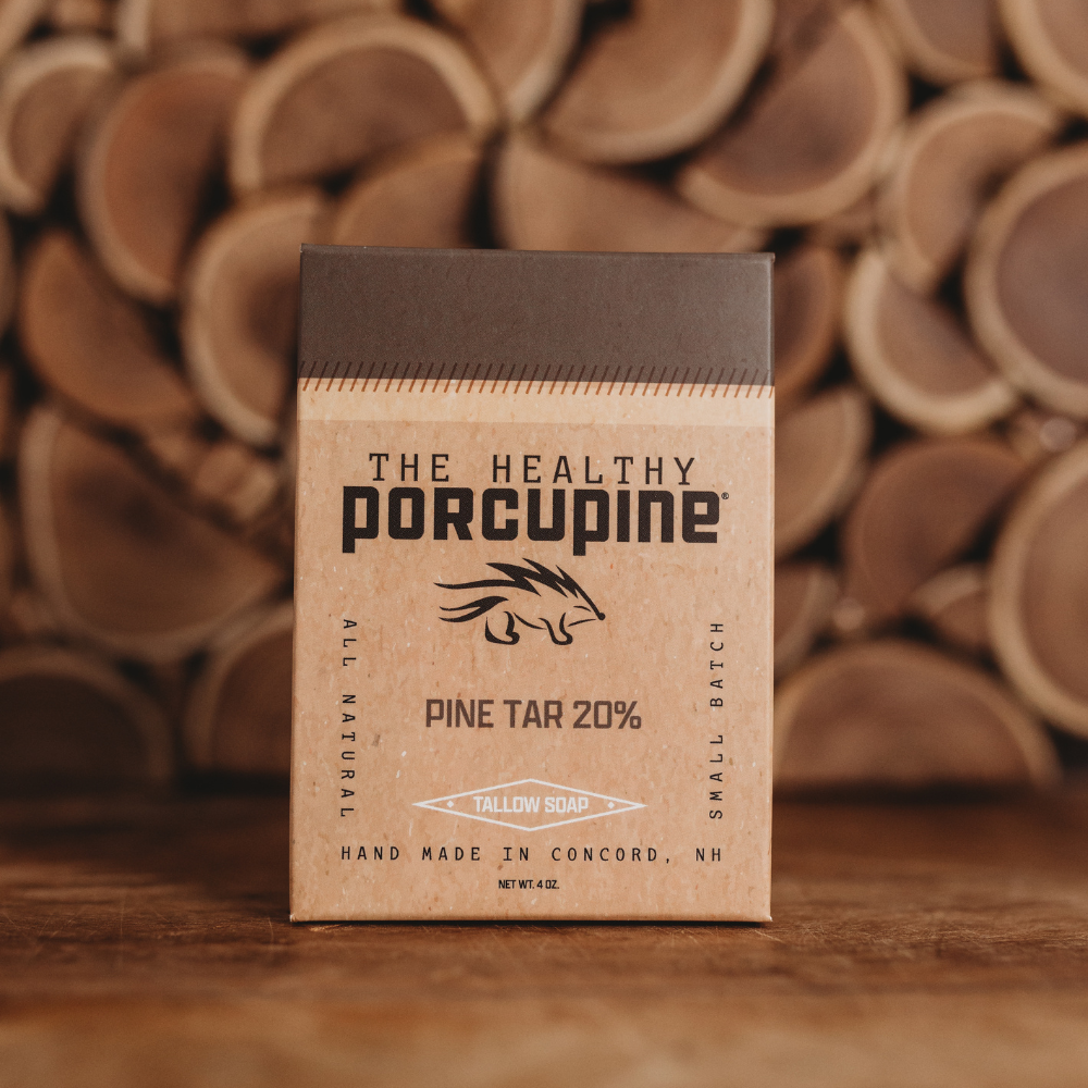 Box of 'The Healthy Porcupine' pine tar product with a wooden background