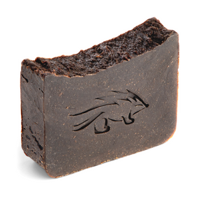 Close up of pine tar soap bar standing on side with porcupine logo etching.
