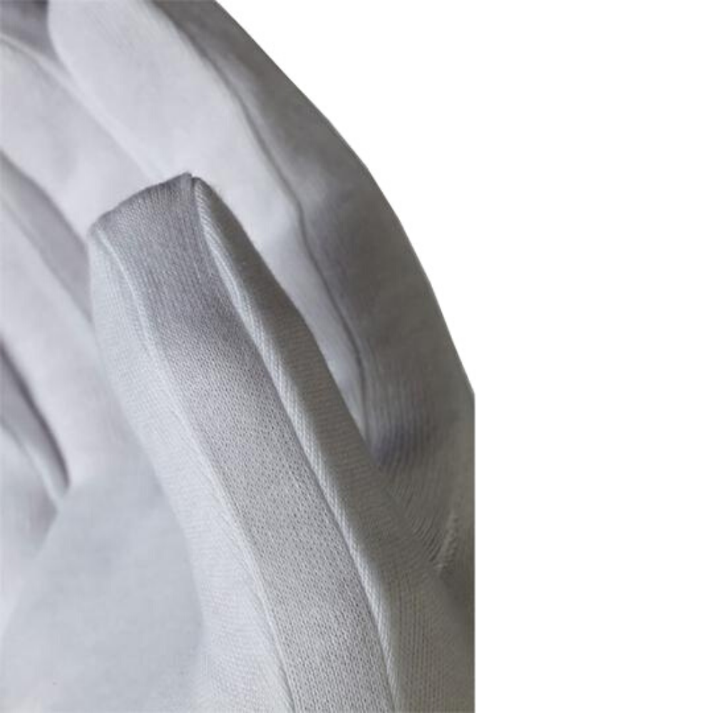 Close up of the gusset on the thumb of a white cotton glove.
