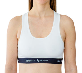 Model wearing a white Remedywear bra as an eczema bra line treatment.