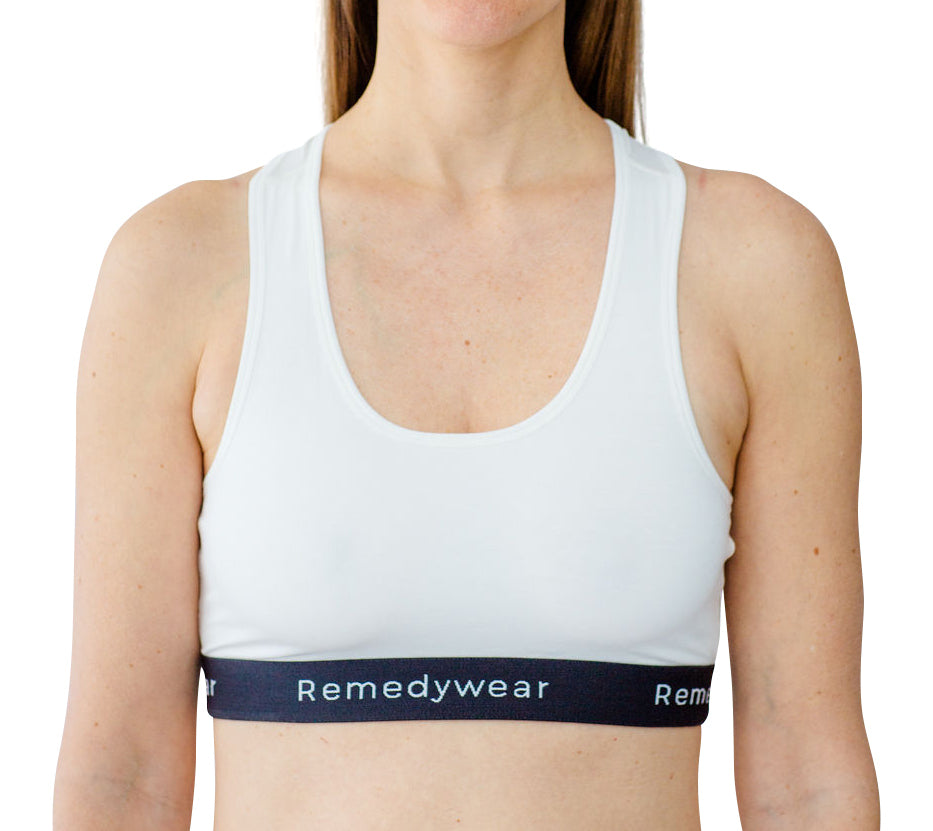 Model wearing a white Remedywear bra as an eczema bra line treatment.