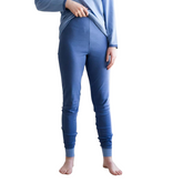 Adult wearing the organic adult pajamas pant for eczema in medium blue with light blue cuffs.