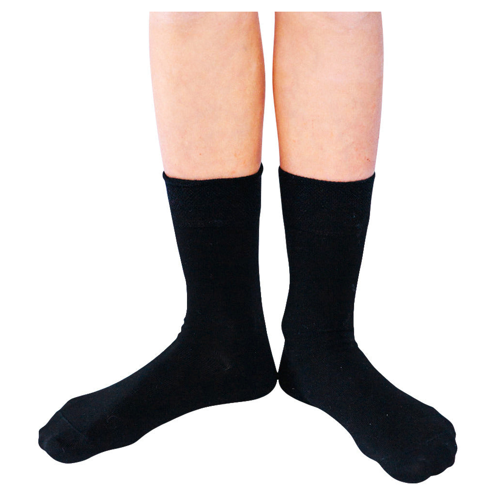 Pair of black Remedywear socks for eczema on a white background.