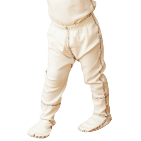Organic cotton footed pants for kids on small child.