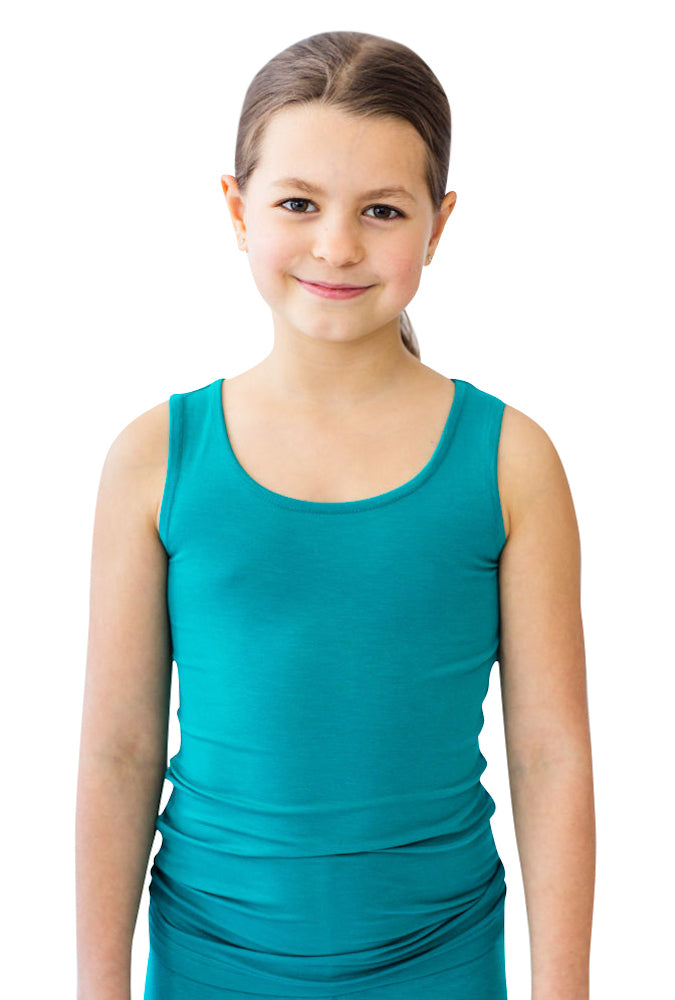 Girl smiling at camera while wearing a teal Remedywear camisole for treating eczema on the chest.