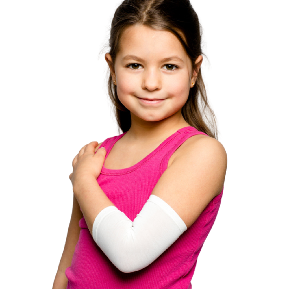 Girl in pink tank top with arm across chest wearing a white Remedywear sleeve for eczema.