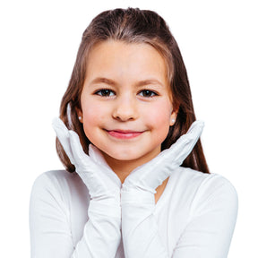 Girl's face framed by her hands wearing white Remedywear kids gloves.