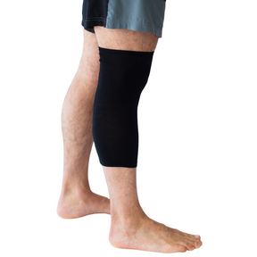 Man's leg covered with a black Remedywear band for eczema.