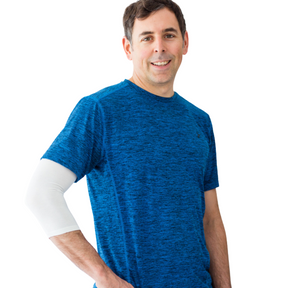 Man in blue exercise shirt wearing a white Remedywear sleeve on his elbow.
