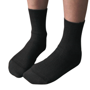 Kids 100% organic cotton socks for eczema in black with ribbing worn on model's feet