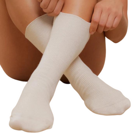 Lightweight natural white socks on a female model with a white background.